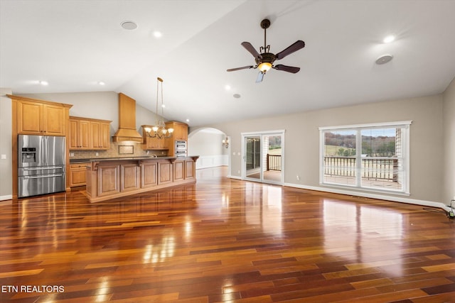 living room featuring dark wood-style floors, arched walkways, baseboards, and ceiling fan with notable chandelier