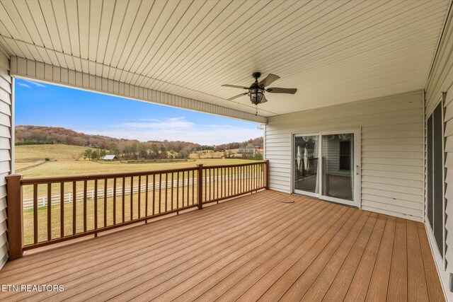 wooden terrace featuring ceiling fan