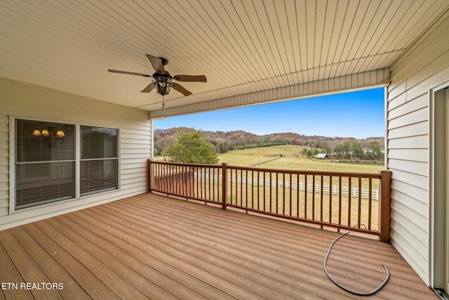 deck with a mountain view and a ceiling fan