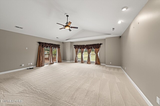 unfurnished living room featuring baseboards, visible vents, a ceiling fan, and light colored carpet