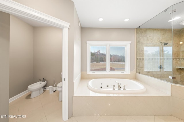 bathroom with toilet, a tub with jets, tile patterned flooring, a tile shower, and a bidet