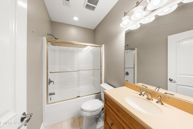 full bathroom with visible vents, toilet, shower / bath combination with glass door, tile patterned floors, and vanity