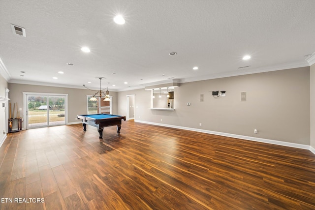 playroom with visible vents, dark wood-type flooring, and ornamental molding