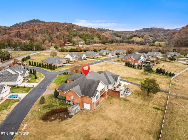 drone / aerial view featuring a residential view and a mountain view