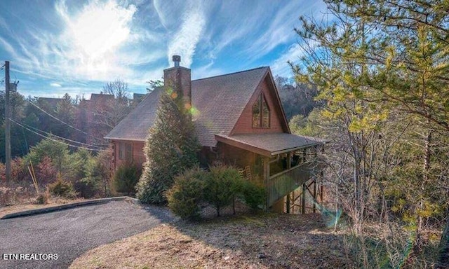 view of property exterior featuring a chimney