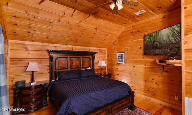 bedroom featuring wooden ceiling, wooden walls, visible vents, and wood finished floors