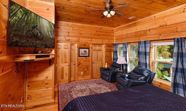 bedroom with wooden ceiling, wood walls, access to exterior, and wood finished floors