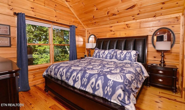 bedroom featuring wooden ceiling, vaulted ceiling, wooden walls, and wood finished floors