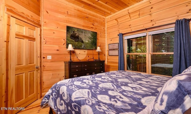 bedroom with wood walls, wooden ceiling, and wood finished floors