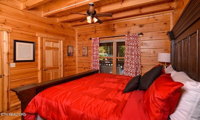 bedroom with wood walls and beamed ceiling