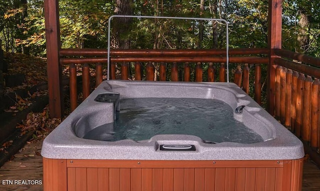 deck with a hot tub