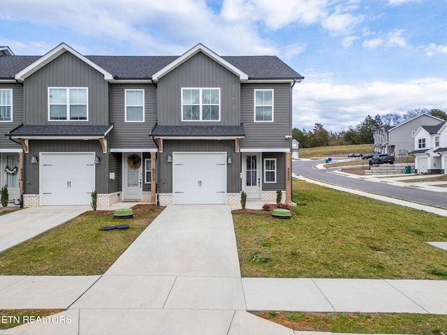 view of front of home featuring a shingled roof, a front yard, concrete driveway, and an attached garage