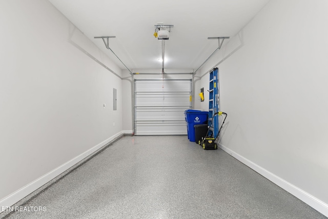 garage featuring a garage door opener, electric panel, and baseboards