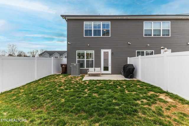 back of house with a patio area, a fenced backyard, and a lawn