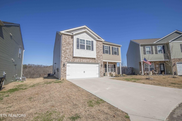 view of front of home with a garage, driveway, brick siding, and central AC unit