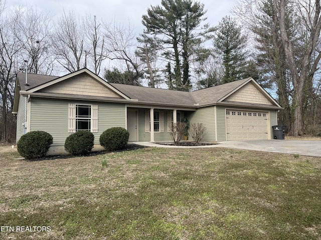 single story home featuring a front yard, an attached garage, and concrete driveway