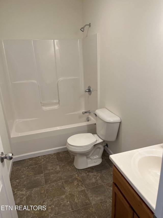 bathroom with tub / shower combination, toilet, and vanity