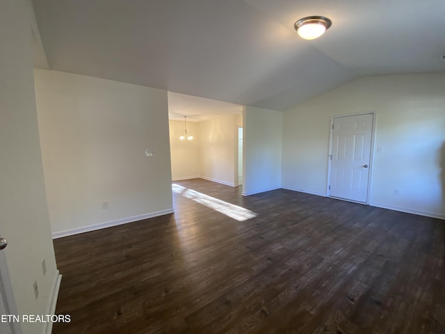 unfurnished room with dark wood-style floors, a chandelier, baseboards, and lofted ceiling