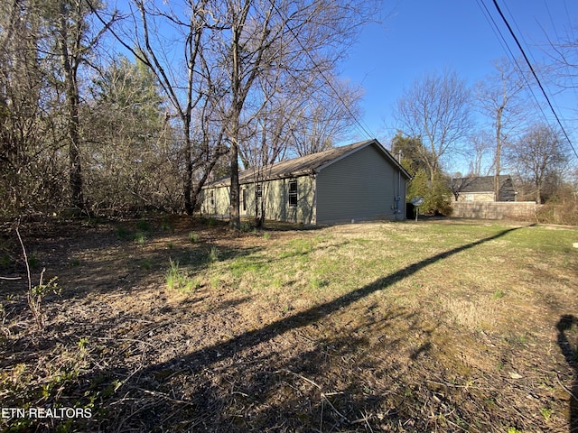 view of side of home with a lawn