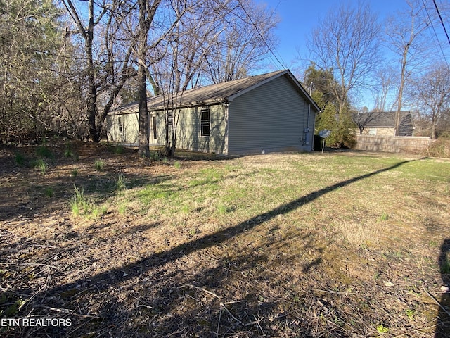 view of side of property featuring a yard