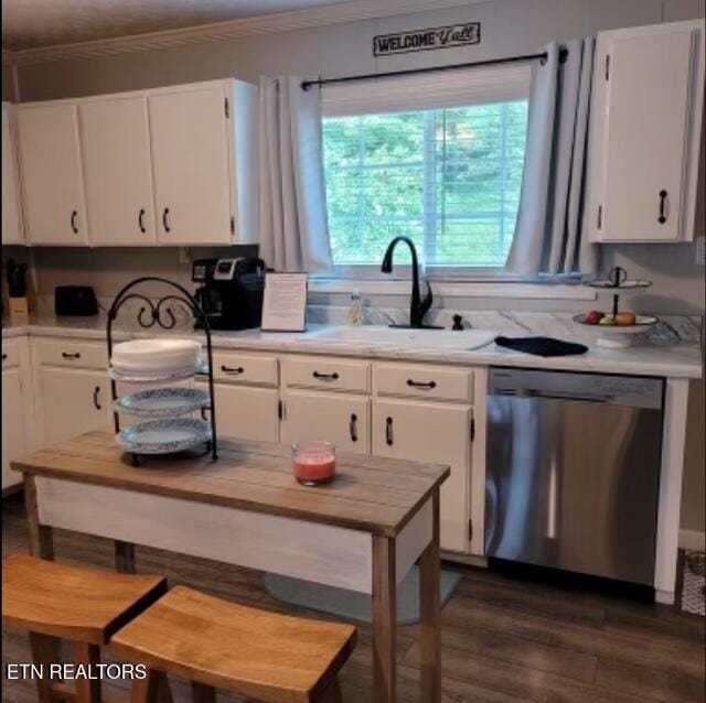 kitchen featuring a sink, ornamental molding, white cabinets, and stainless steel dishwasher