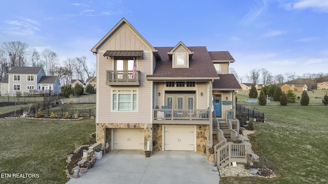 view of front of home featuring concrete driveway, a balcony, stairway, a front lawn, and board and batten siding