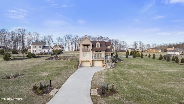 exterior space with concrete driveway, a lawn, fence, a garage, and stairs