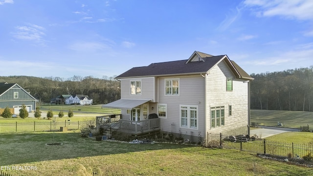 back of house with a yard and a fenced backyard