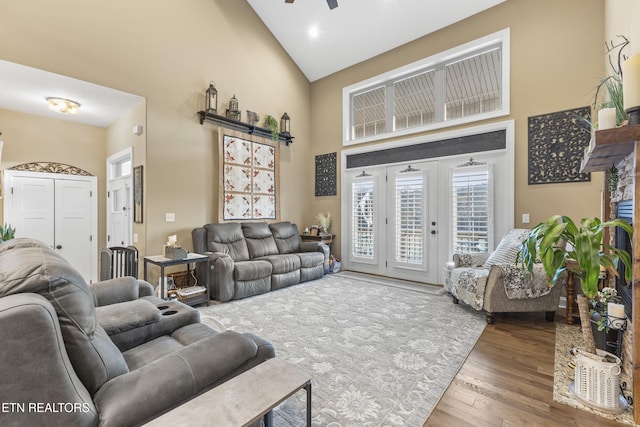 living area featuring ceiling fan, high vaulted ceiling, and wood finished floors