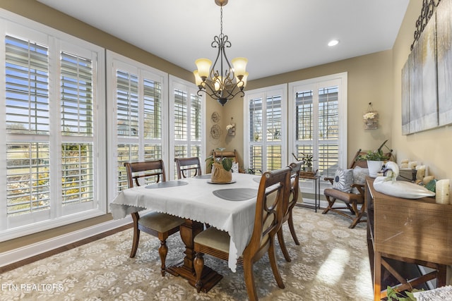 dining space with recessed lighting and an inviting chandelier