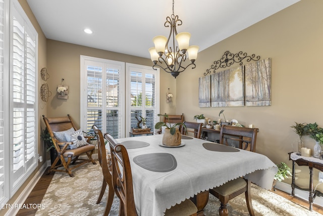 dining room with a chandelier, recessed lighting, baseboards, and wood finished floors