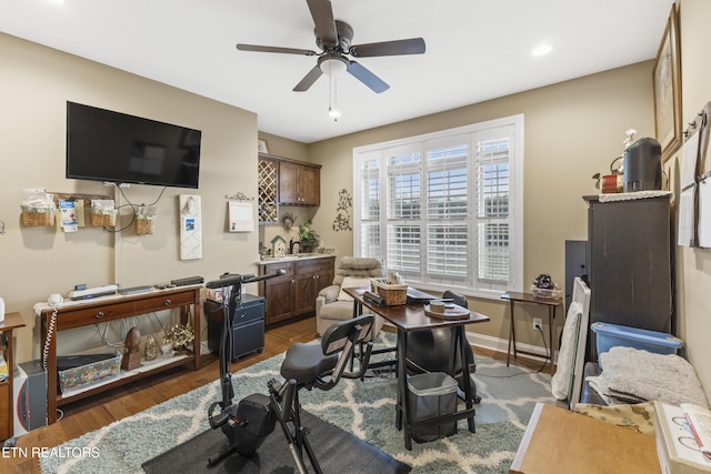 office space featuring ceiling fan, baseboards, and wood finished floors