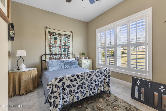 carpeted bedroom with baseboards and a ceiling fan