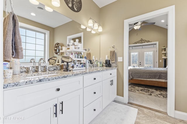 full bathroom with connected bathroom, a sink, visible vents, french doors, and double vanity