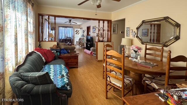 interior space featuring crown molding, a ceiling fan, and wood finished floors