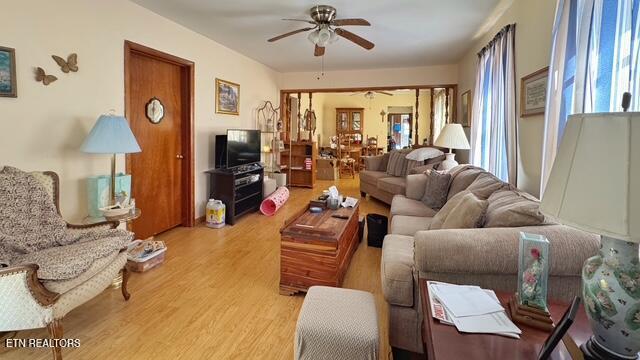 living room featuring ceiling fan and wood finished floors