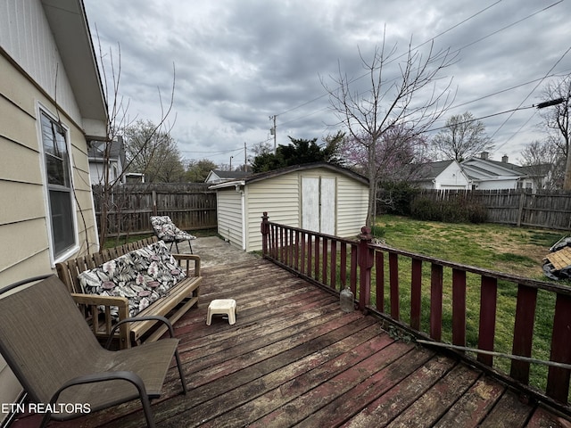 1640 Lodge St, Alcoa, TN 37701 - wooden deck with a fenced backyard, an outbuilding, a lawn, and a storage shed