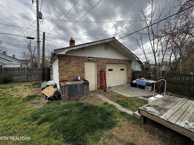 1640 Lodge St, Alcoa, TN 37701 - exterior space featuring brick siding, a fenced backyard, a garage, and a chimney