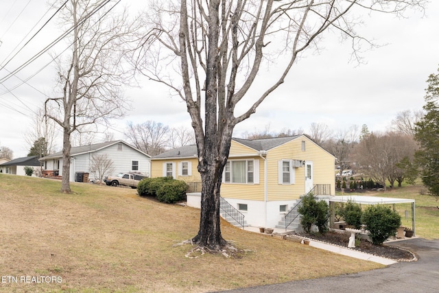 view of side of property with a lawn and stairs