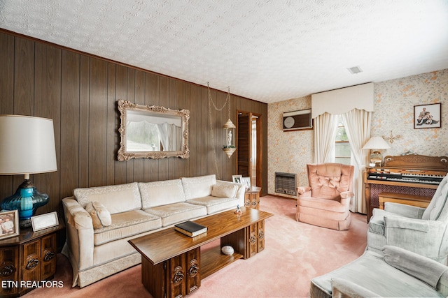 carpeted living area with a large fireplace, a textured ceiling, and heating unit