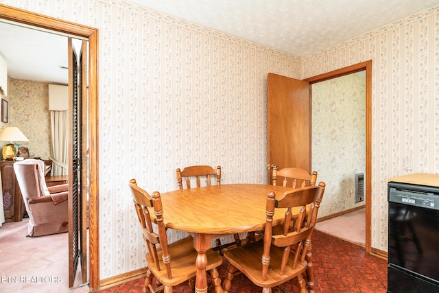 dining area featuring wallpapered walls, baseboards, and a textured ceiling