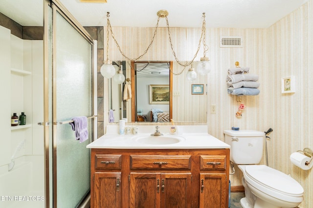 bathroom featuring wallpapered walls, a stall shower, connected bathroom, toilet, and vanity