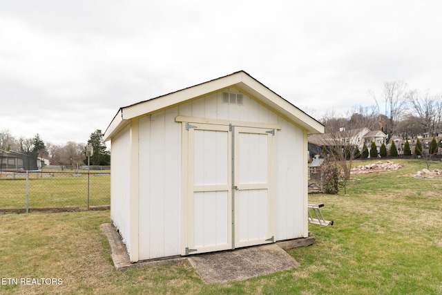 view of shed featuring fence