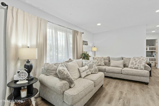 living area featuring wood finished floors and recessed lighting