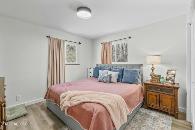 bedroom with baseboards and light wood-style floors