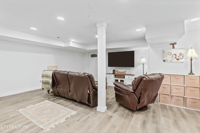 living area with baseboards, light wood finished floors, decorative columns, and recessed lighting