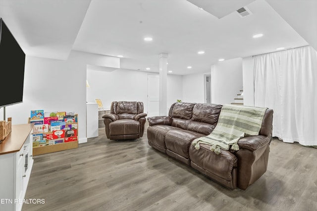 living room featuring stairs, recessed lighting, visible vents, and wood finished floors