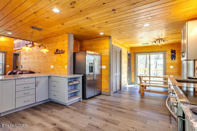 1012 Ravens Ford Way, Sevierville, TN 37876 - kitchen with wooden ceiling, light wood-style flooring, appliances with stainless steel finishes, gray cabinets, and open shelves