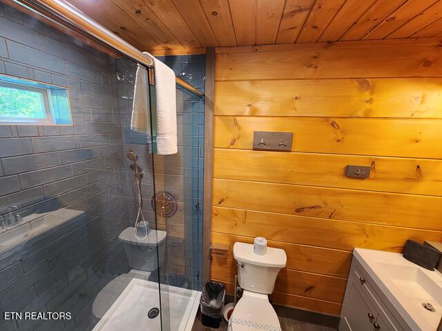 1012 Ravens Ford Way, Sevierville, TN 37876 - full bathroom with wooden ceiling, toilet, wood walls, vanity, and a shower stall