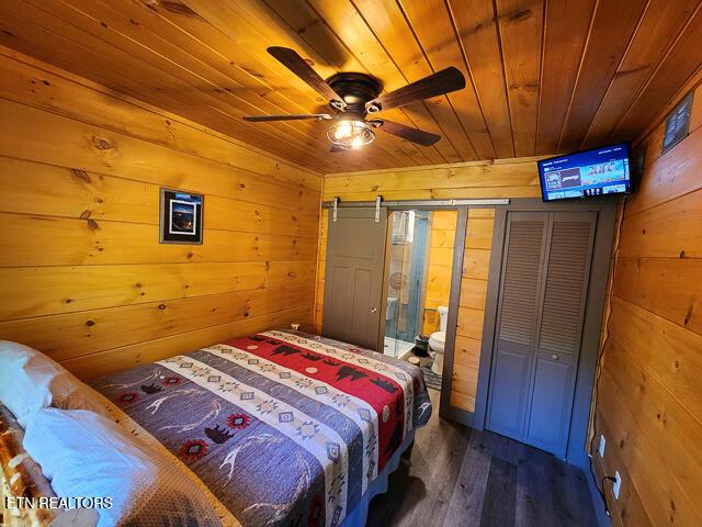 1012 Ravens Ford Way, Sevierville, TN 37876 - bedroom featuring dark wood-type flooring, wood ceiling, and wood walls